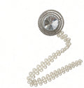 Crystal and pearl curtain tieback on white, round crystal medallion with a curved pearl bead chain