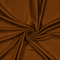 Dark brown plain velvet curtain fabric arranged in a swirl showing its rich drape

