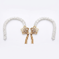 Two floral pearl curtain tiebacks on white, gold flower medallions with crystal center's and tassels