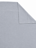 Grey velvet curtain panel laid flat with one corner folded to show the reverse side
