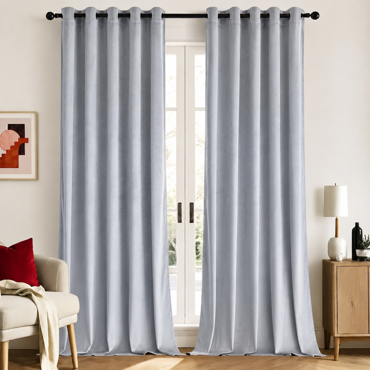 Grey velvet room-darkening curtains, set of 2, hanging on a black rod in a bright living room
