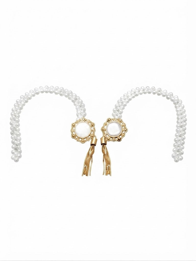 Two opalescent and pearl curtain tiebacks laid on white, each with a gold medallion and chain tassel