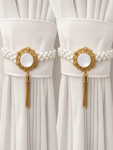 Two opalescent pearl curtain tiebacks gathering white curtain panels either side of a window