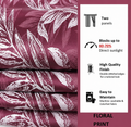 Folded stack of wine floral curtain fabric beside a panel stating the curtains block 60-70% of direct sunlight